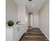 Hallway with wood-style flooring and a built-in sink with a plant for decor at 5424 Freddys Trl, Parker, CO 80134