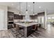 Modern kitchen with stainless appliances, a large island with seating, and stylish pendant lighting at 5424 Freddys Trl, Parker, CO 80134