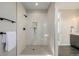 Walk-in shower featuring marble-look tile surround, niche, and matte black shower fixtures at 5424 Freddys Trl, Parker, CO 80134
