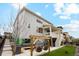 Backyard view of a two-story home, showing a covered deck and an outdoor lounge area at 6263 E 142Nd Pl, Thornton, CO 80602