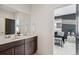 Bathroom with double sink vanity and view into bedroom at 6263 E 142Nd Pl, Thornton, CO 80602