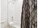 Bright bathroom features a shower and tub combination with white tile surround at 6263 E 142Nd Pl, Thornton, CO 80602