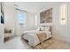 Well-lit bedroom with hardwood floors, bright white walls, decoratively framed print and a large window at 6263 E 142Nd Pl, Thornton, CO 80602