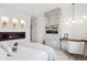 Modern bedroom features fireplace, mounted television, recessed shelving, light fixture and a small desk at 6263 E 142Nd Pl, Thornton, CO 80602