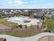 Aerial view of the community clubhouse with a pool area, landscaping, and outdoor seating at 6263 E 142Nd Pl, Thornton, CO 80602
