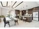 Modern kitchen and dining area with sleek cabinetry, stainless steel appliances, and stylish lighting fixtures at 6263 E 142Nd Pl, Thornton, CO 80602