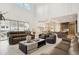 Spacious living room featuring sleek furniture, fireplace, soaring ceilings and an open layout with the kitchen at 6263 E 142Nd Pl, Thornton, CO 80602
