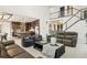 Spacious living room featuring sleek furniture, fireplace, soaring ceilings and an open layout with the kitchen at 6263 E 142Nd Pl, Thornton, CO 80602