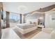 Bright main bedroom featuring an upholstered bed, modern lighting, and decorative accent wall with overhead lighting at 6263 E 142Nd Pl, Thornton, CO 80602