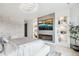 Beautiful bedroom with modern fireplace, recessed shelving, accent wall and television above the fireplace at 6263 E 142Nd Pl, Thornton, CO 80602