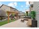 Cozy outdoor patio with a fire pit, modern seating, and lush landscaping at 6263 E 142Nd Pl, Thornton, CO 80602