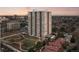 High-rise condominium building in an urban setting with parks and surrounding greenery at 3131 E Alameda Ave # 1203, Denver, CO 80209