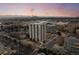 Stunning aerial view of a high-rise apartment building with city skyline backdrop at sunset at 3131 E Alameda Ave # 1203, Denver, CO 80209