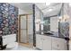 Patterned bathroom featuring a glass shower stall and marble countertops at 3131 E Alameda Ave # 1203, Denver, CO 80209