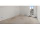 Bright bedroom with neutral carpet, white walls, and large windows offering city views at 3131 E Alameda Ave # 1203, Denver, CO 80209