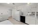 Efficient kitchen with mirrored backsplash, white cabinets, and essential appliances included at 3131 E Alameda Ave # 1203, Denver, CO 80209