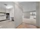 Bright kitchen with white cabinets, appliances, and a pass-through window to the living area at 3131 E Alameda Ave # 1203, Denver, CO 80209