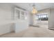 Open living space with balcony and built-in shelving plus modern light fixture at 3131 E Alameda Ave # 1203, Denver, CO 80209