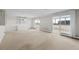 Open floor plan with built-in shelving, carpeted living area, and access to the balcony at 3131 E Alameda Ave # 1203, Denver, CO 80209