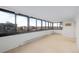 Carpeted living room featuring expansive windows providing cityscape views at 3131 E Alameda Ave # 1203, Denver, CO 80209