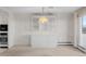 Living area with buffet, pendant lighting and view of the balcony at 3131 E Alameda Ave # 1203, Denver, CO 80209