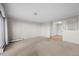Spacious living room with carpet flooring, neutral walls, and entryway to kitchen area at 3131 E Alameda Ave # 1203, Denver, CO 80209