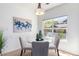 Bright dining area with a glass table, chairs, stylish lighting, and a large window at 8200 E 8Th Ave # 8101, Denver, CO 80230