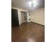 This bedroom boasts wood flooring, shelving, and a stacked washer and dryer for convenience at 3101 W Jefferson Ave, Englewood, CO 80110