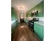 Modern kitchen featuring stainless steel appliances and green cabinetry at 3101 W Jefferson Ave, Englewood, CO 80110