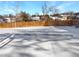 Snowy backyard with wooden fence and garden beds at 928 S Ventura St, Aurora, CO 80017