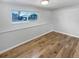 Finished basement room with wood floors and large window at 928 S Ventura St, Aurora, CO 80017