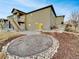 Exterior backyard of home featuring a gravel firepit and a stairway leading to a deck at 4877 Cattle Cross Rd, Castle Rock, CO 80104