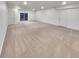 Large, carpeted basement with ample space for storage or recreation with access to the outside at 4877 Cattle Cross Rd, Castle Rock, CO 80104