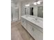 Bathroom featuring double sinks, white cabinetry, and glass-enclosed shower at 4877 Cattle Cross Rd, Castle Rock, CO 80104