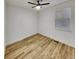 Bright bedroom with a ceiling fan and wood-look flooring at 4877 Cattle Cross Rd, Castle Rock, CO 80104