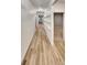 Long hallway with hardwood floors and white walls, leading to other rooms in the home at 4877 Cattle Cross Rd, Castle Rock, CO 80104