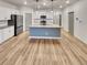 Spacious kitchen with a center island, white cabinets, stainless appliances, and hardwood floors at 4877 Cattle Cross Rd, Castle Rock, CO 80104