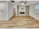 Bright, modern living room featuring a fireplace and hardwood floors at 4877 Cattle Cross Rd, Castle Rock, CO 80104