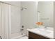 Bright bathroom featuring a white tile shower, modern white vanity, and new hardware for a clean look at 3308 W 17Th Ave, Denver, CO 80204