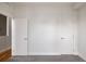 Bedroom with gray carpet, bright white walls, and featuring two white doors on opposite sides of the room at 3308 W 17Th Ave, Denver, CO 80204