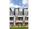Contemporary townhome showcasing modern architecture, brick facade, and sleek balconies at 3308 W 17Th Ave, Denver, CO 80204