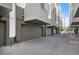 A view of the garages with a concrete driveway and a side door with gray siding at 3308 W 17Th Ave, Denver, CO 80204