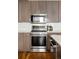 A modern kitchen with stainless steel appliances, wood cabinets, and white subway tile backsplash at 3308 W 17Th Ave, Denver, CO 80204