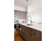 A modern kitchen with stainless steel appliances, wood cabinets, and a center island with a sink at 3308 W 17Th Ave, Denver, CO 80204