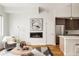 An open-concept living space with a modern fireplace, comfortable seating, and partial view of the kitchen at 3308 W 17Th Ave, Denver, CO 80204