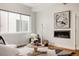 A bright living room with a modern fireplace, comfortable seating, and an attractive accent rug at 3308 W 17Th Ave, Denver, CO 80204
