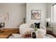 A comfortable living room featuring a curved sofa, modern art and light fixtures, and hardwood floors at 3308 W 17Th Ave, Denver, CO 80204