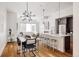 Open-concept living space featuring a modern kitchen island, dining area, and living room at 3308 W 17Th Ave, Denver, CO 80204