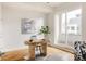 Sunlit office space with a unique wooden desk, hardwood floors, and sliding glass doors leading to an outdoor patio at 3308 W 17Th Ave, Denver, CO 80204