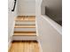 Elegant stairway featuring hardwood steps, crisp white risers, and a modern design at 3308 W 17Th Ave, Denver, CO 80204